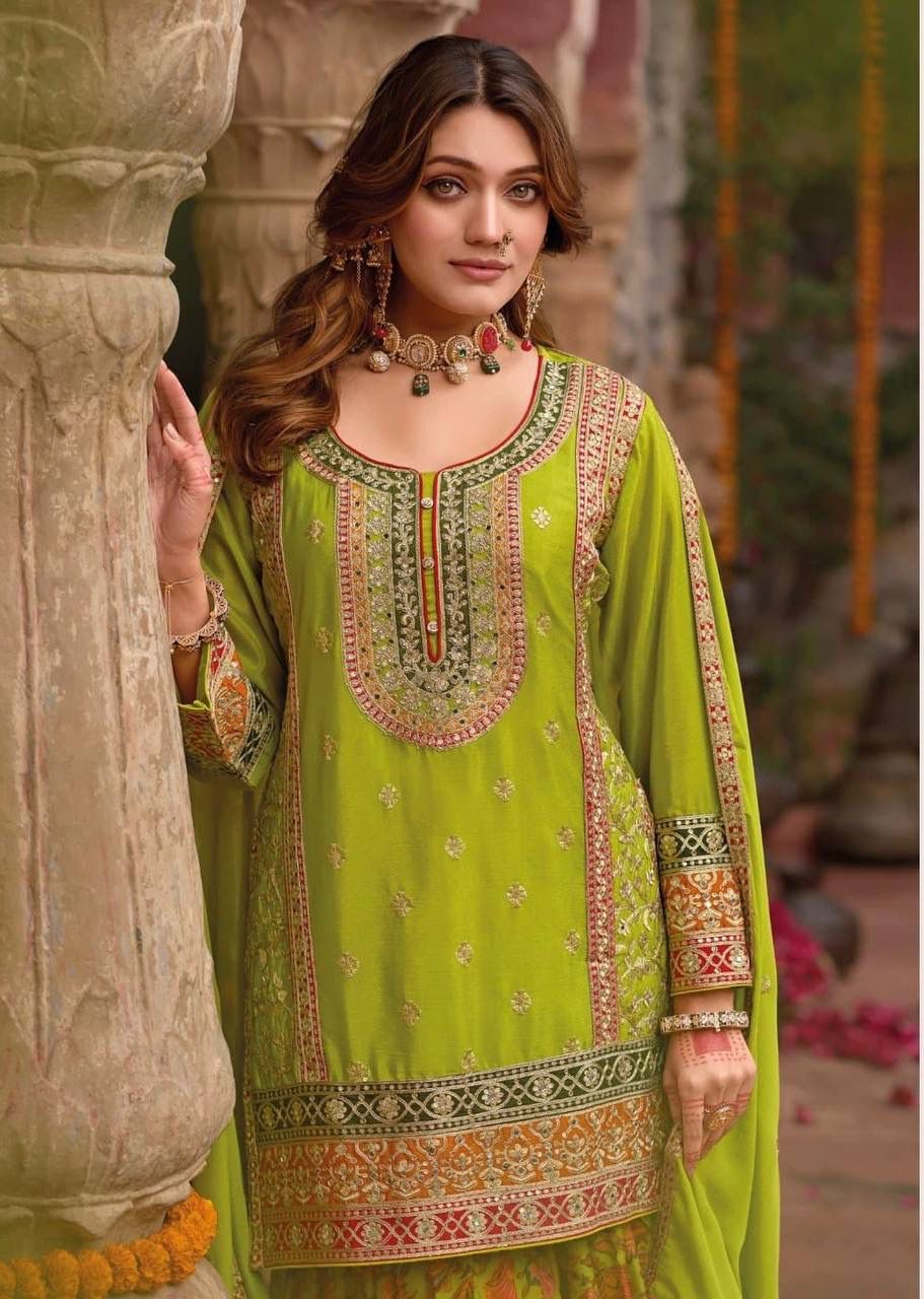 Woman wearing a green embroidered traditional outfit in an outdoor setting.