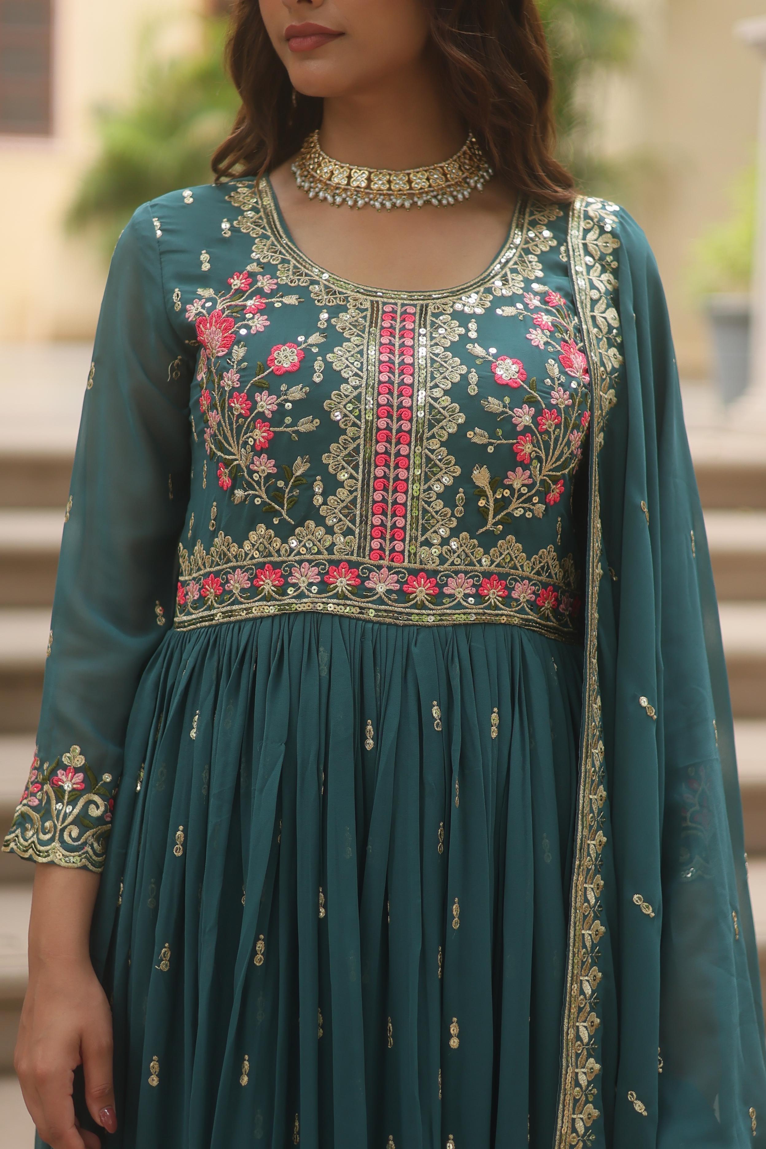 Teal embroidered traditional outfit with floral patterns