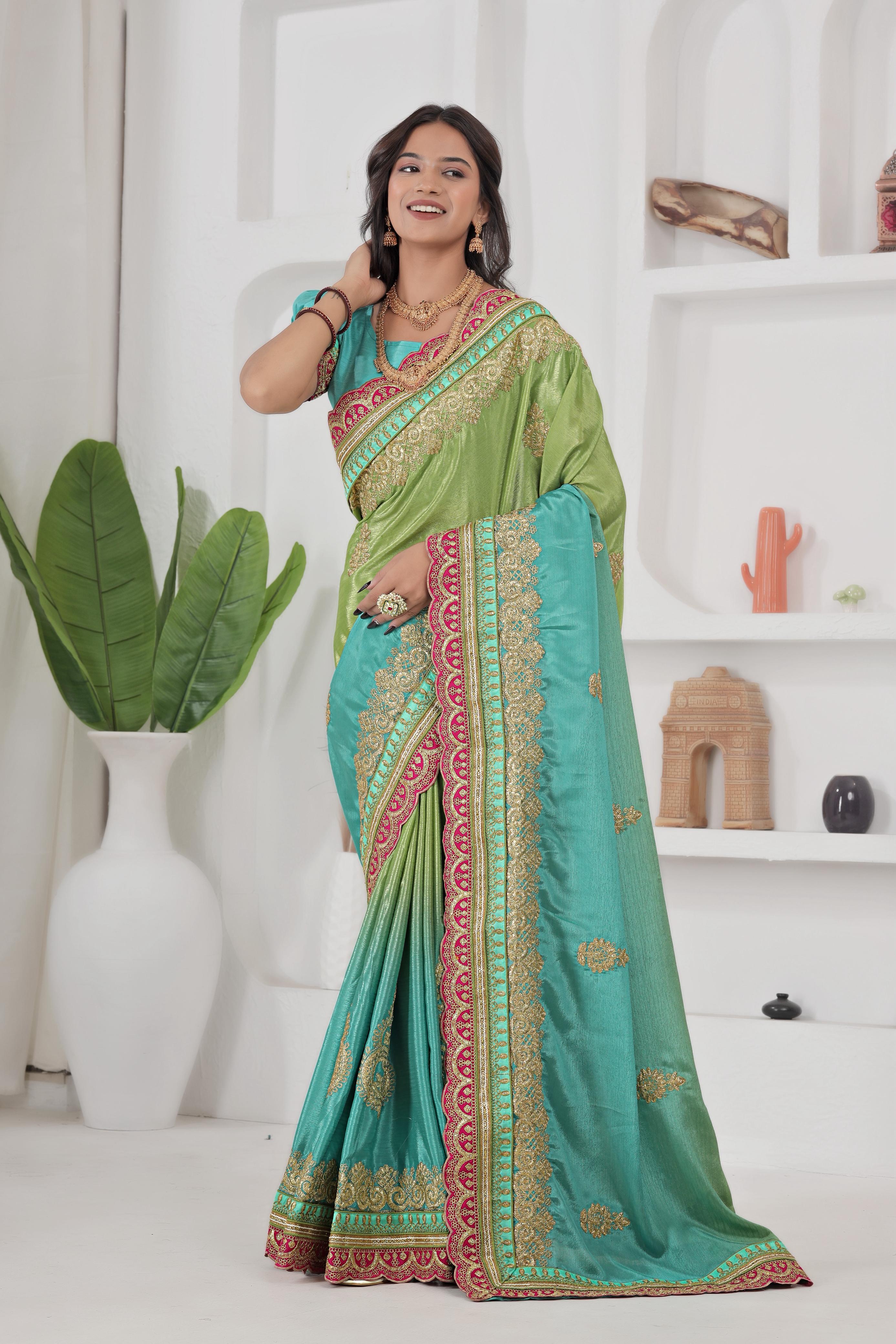 Woman wearing a green and blue saree with a white background