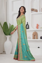Woman wearing a green and blue saree with a white background