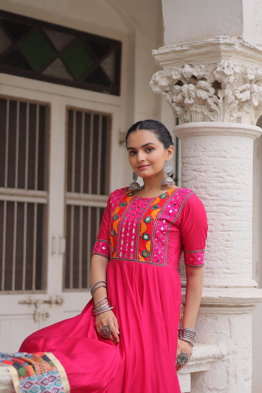 Close-up of mirror work and multicolor printed border on gown