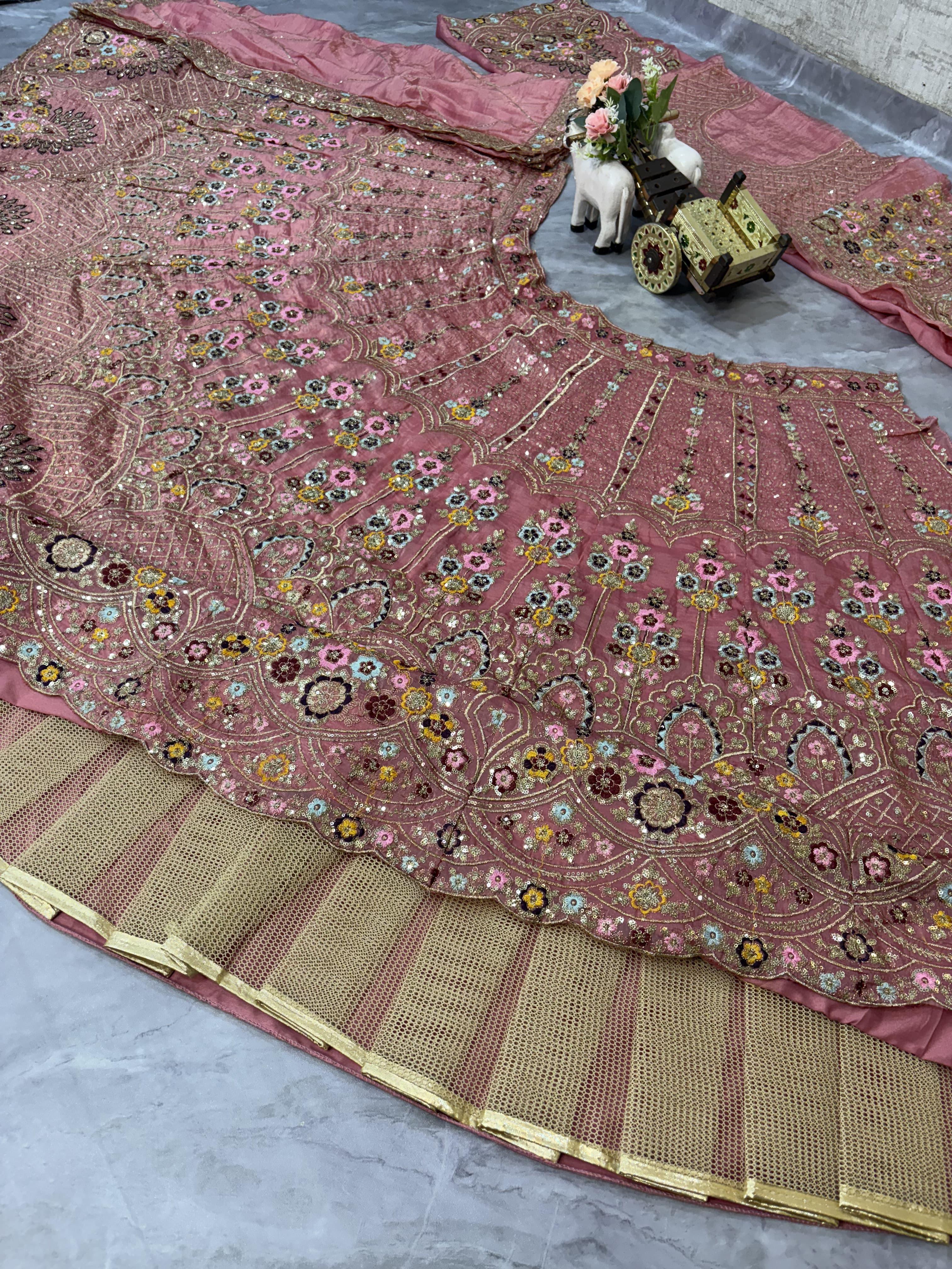 Pink embroidered lehenag with a decorative border and can can.