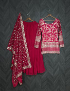 Red traditional outfit with floral patterns on a dark textured background