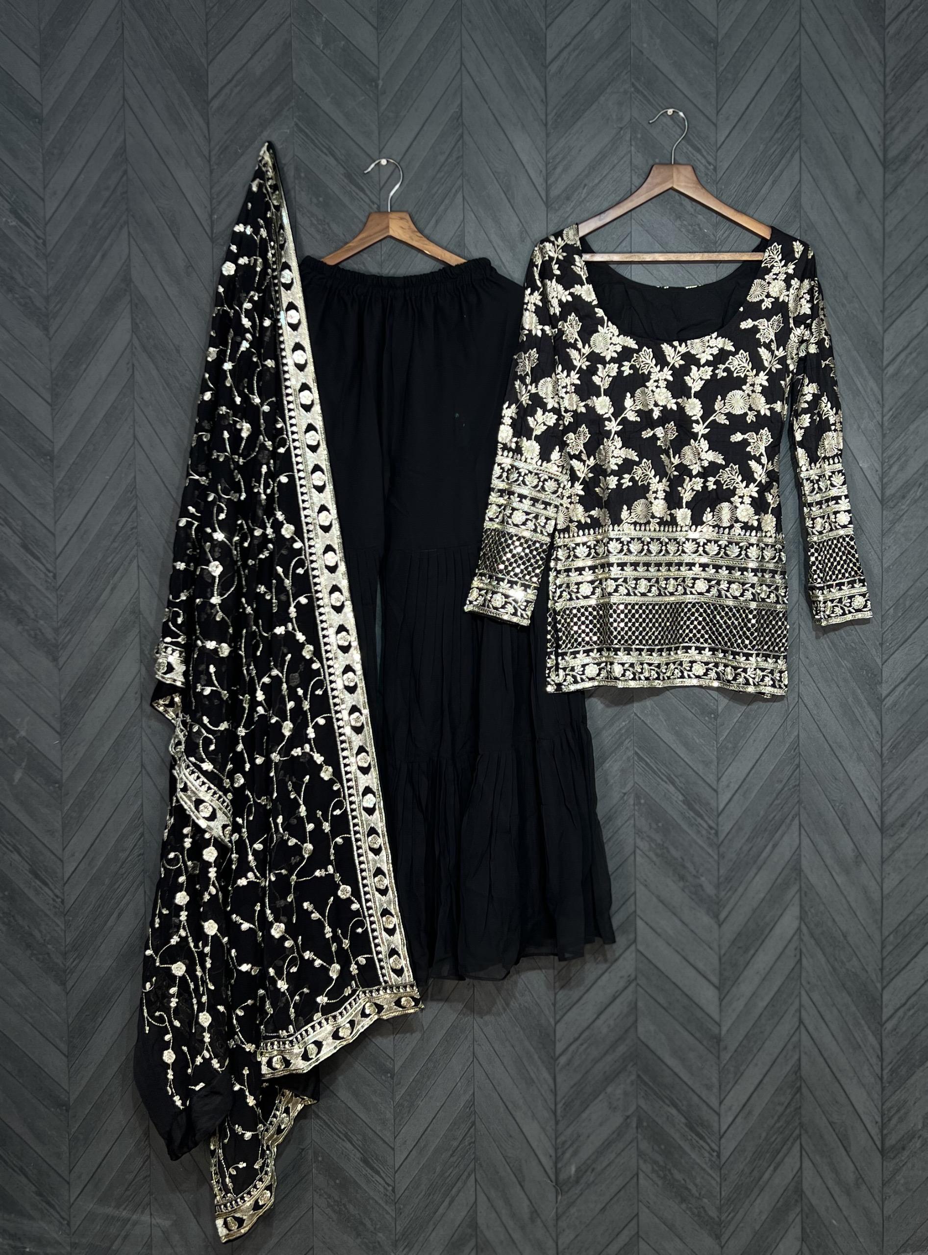 Black and white patterned outfit with a long black skirt on a gray chevron-patterned background