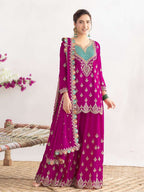 Woman wearing a vibrant purple traditional outfit with intricate designs on a white background