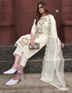 Woman in traditional outfit with embroidery sitting on steps.