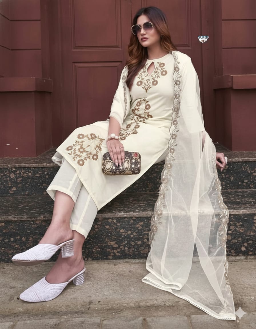 Woman in traditional outfit with embroidery sitting on steps.