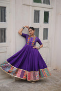 Purple Navratri Anarkali gown with mirror work and traditional embroidery
