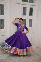 Purple Navratri Anarkali gown with mirror work and traditional embroidery
