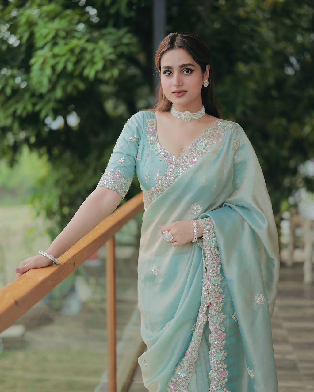Close-up of embroidery work on satin silk saree with floral sequins design
