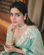Model wearing designer sea green party wear satin silk saree with embroidery